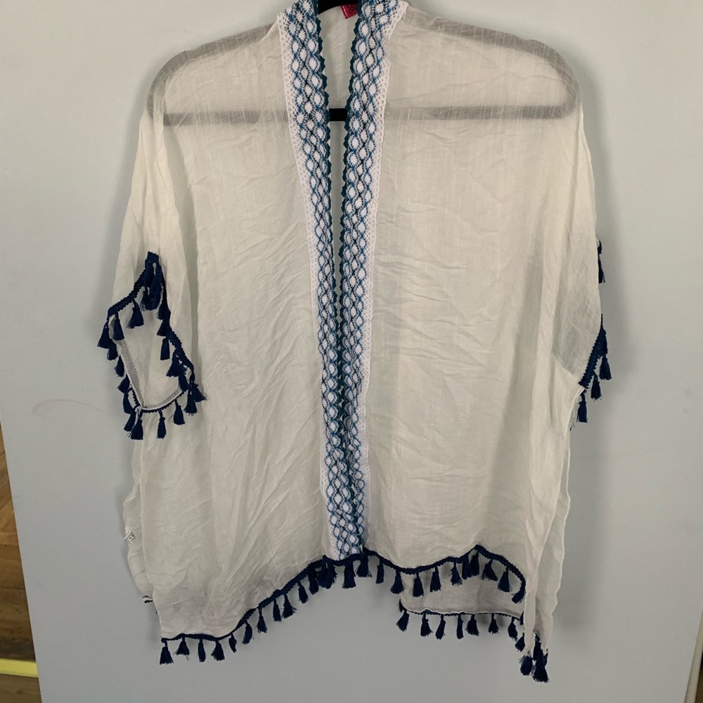 White summer wrap with blue tassels on sleeves